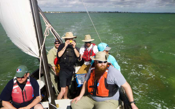 a group of veterans navigate open waters on an outward bound sailing trip